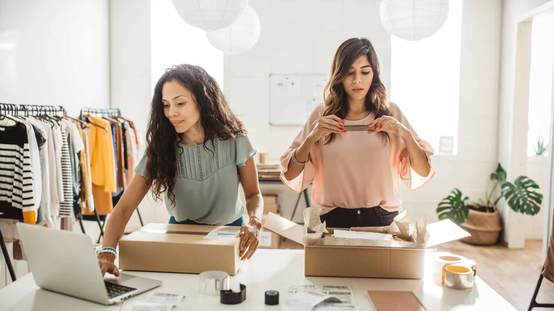 two women are packing orders for their online business